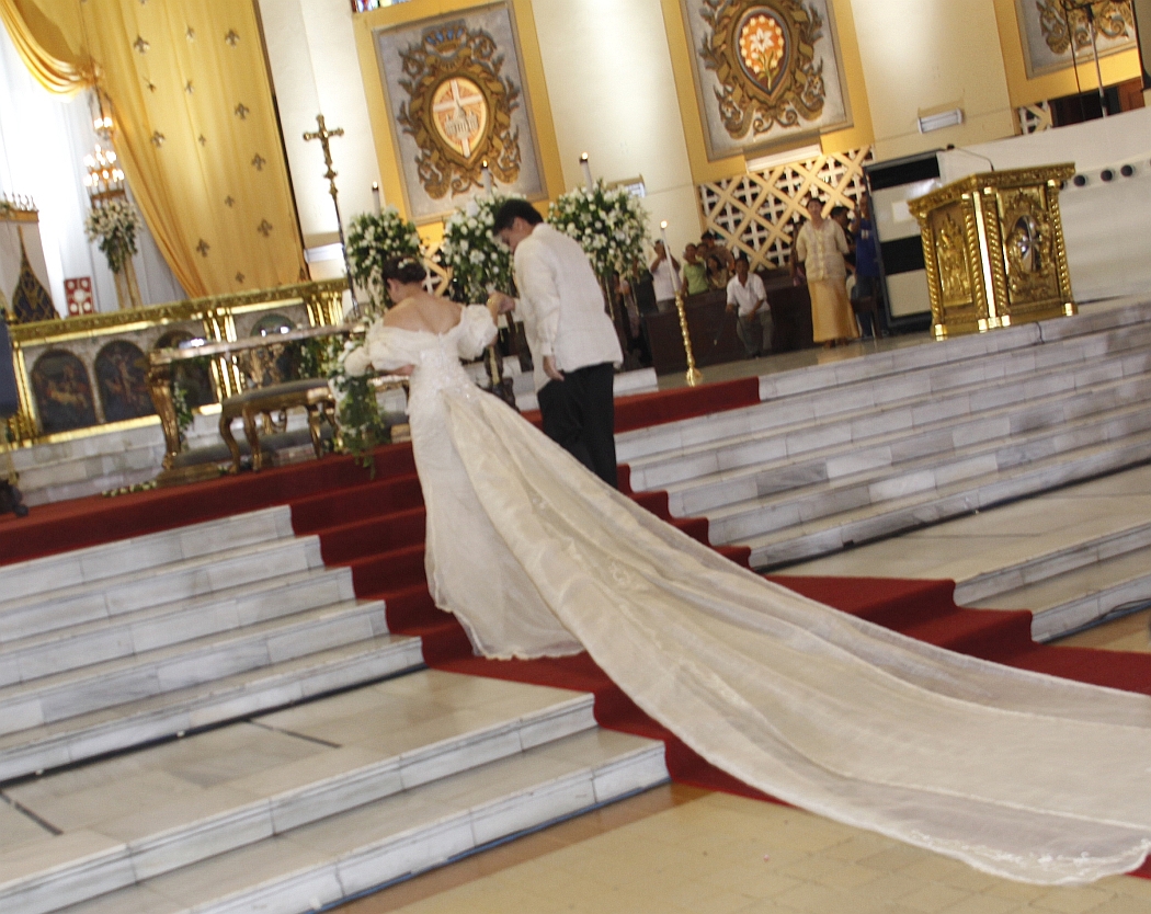The bride and groom take their places in front of the altar at Santo Domingo Church.